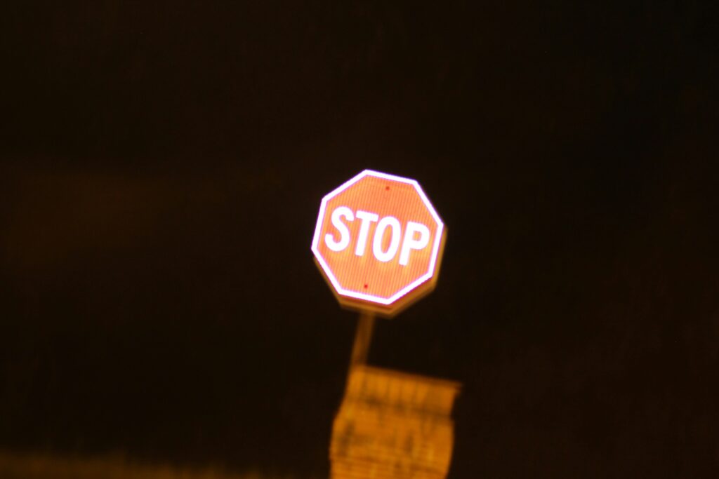 Stop sign against dark sky