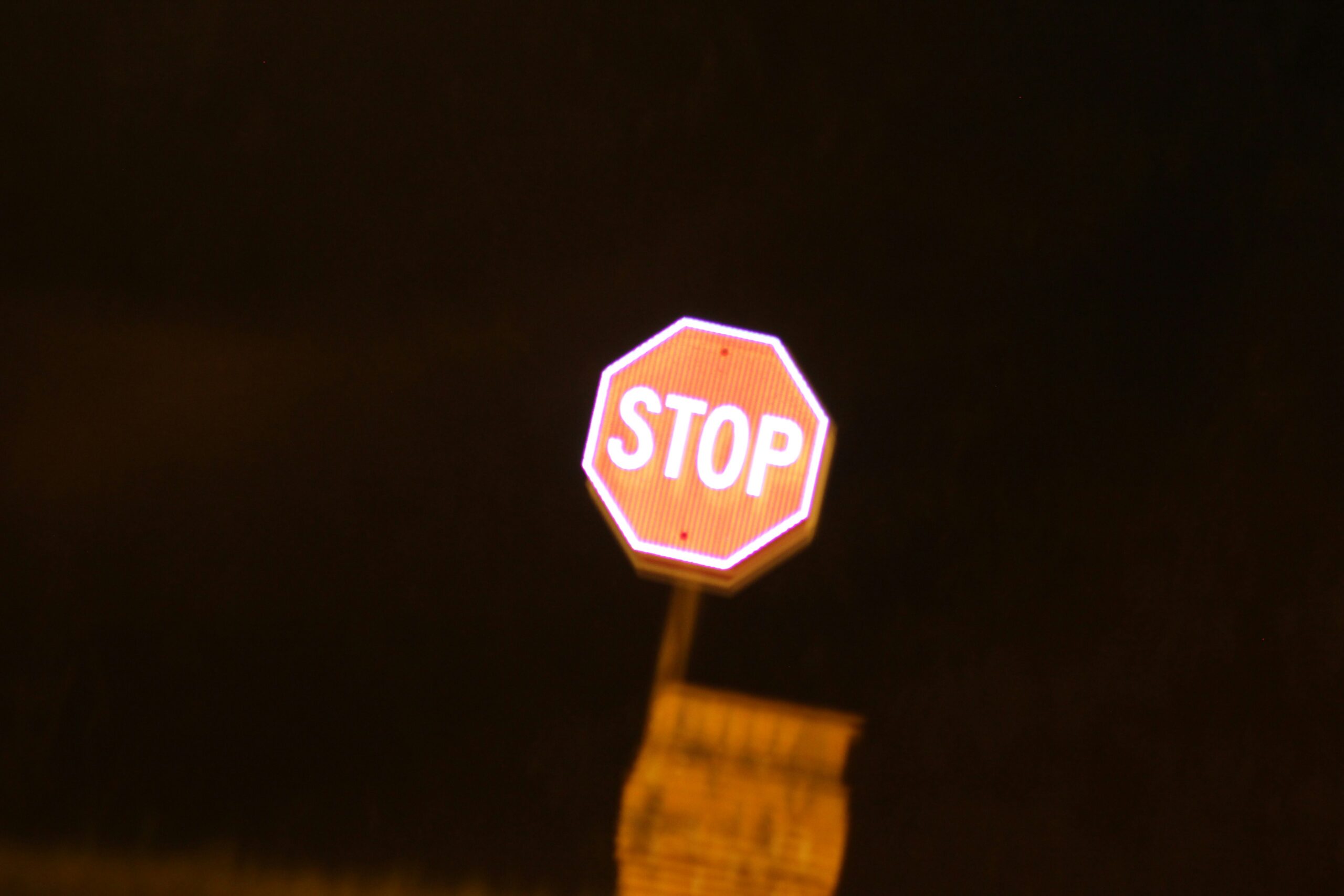 Stop sign against dark sky